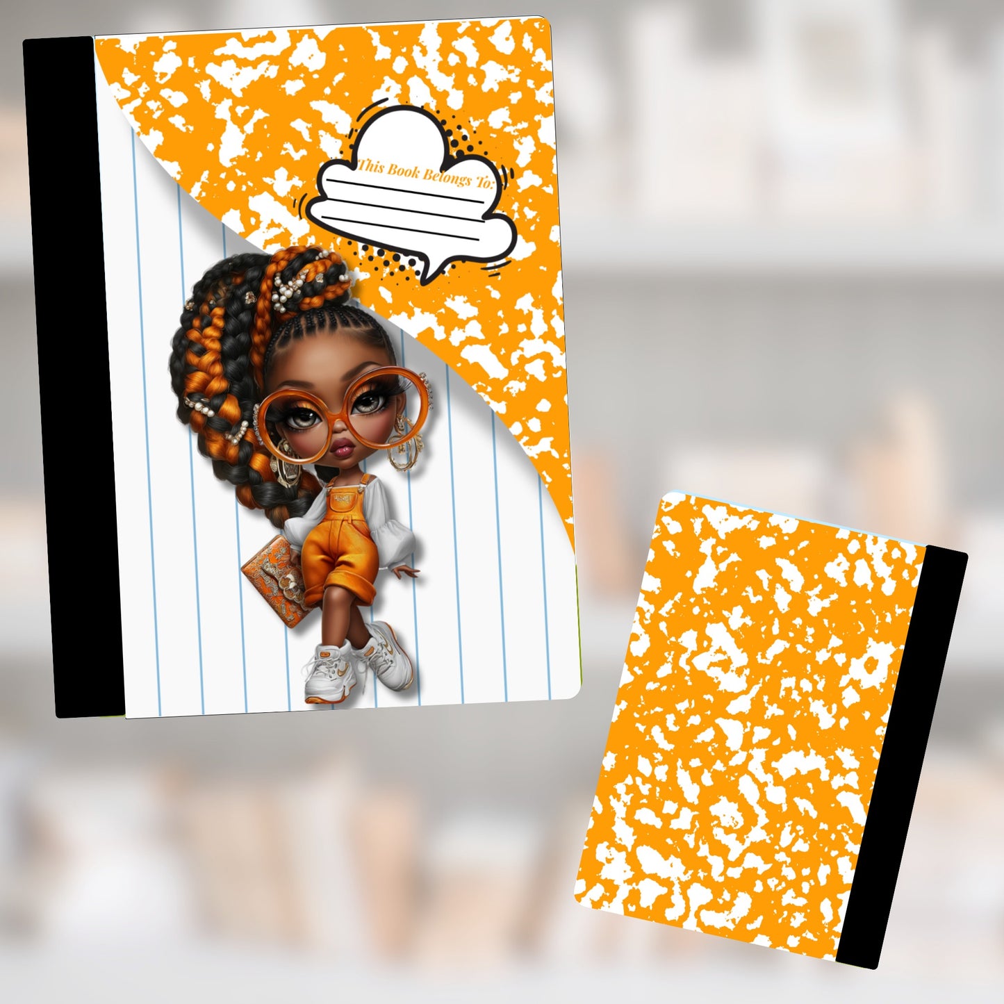 Notebook with a cartoon girl and "This Book Belongs To:" text on orange speckled cover.