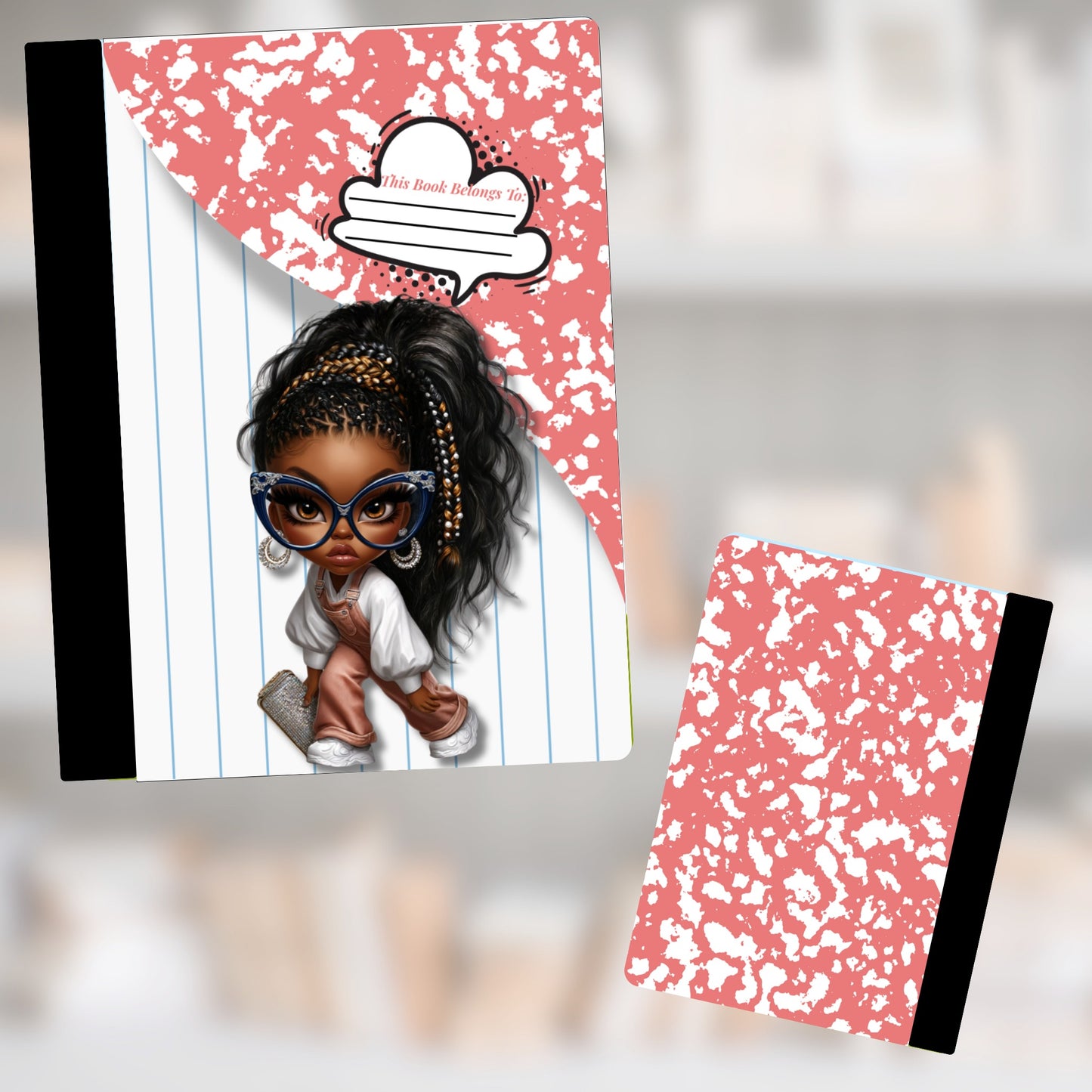 Composition notebook with stylized girl character and "This Book Belongs To:" text.