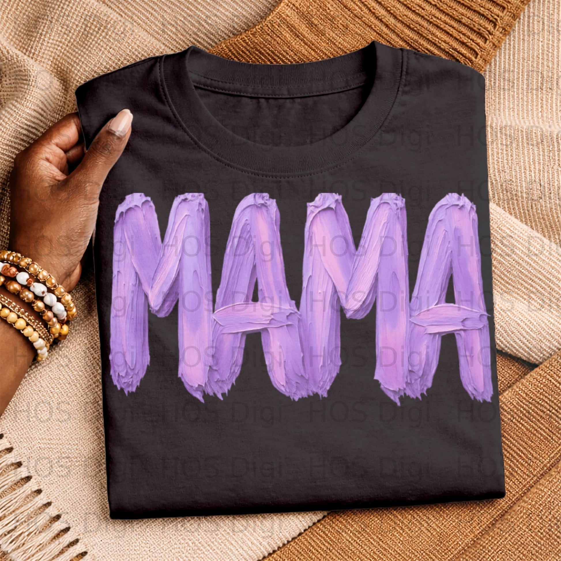 Black t-shirt with "MAMA" in textured purple lettering.