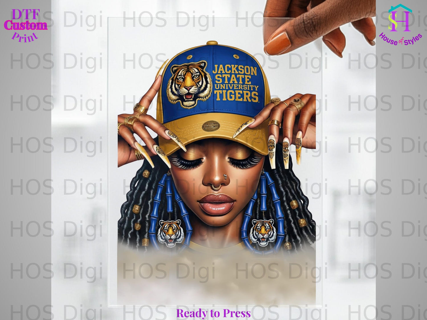 Woman wearing Jackson State Tigers hat and earrings, braids, detailed nails.