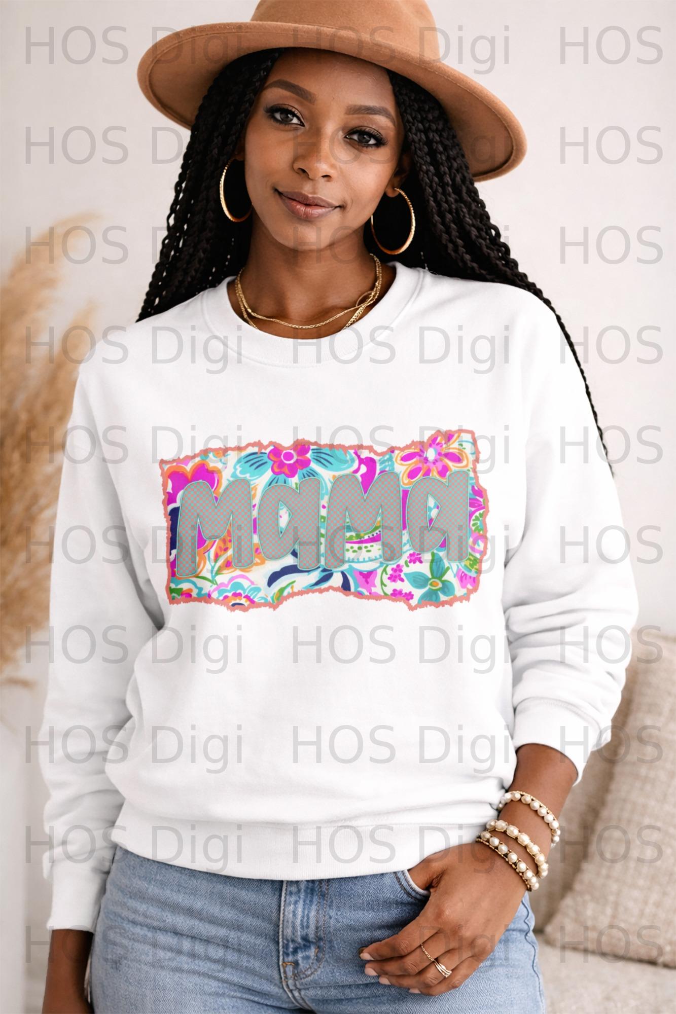 Woman wearing a white sweatshirt with "MAMA" in colorful floral letters.