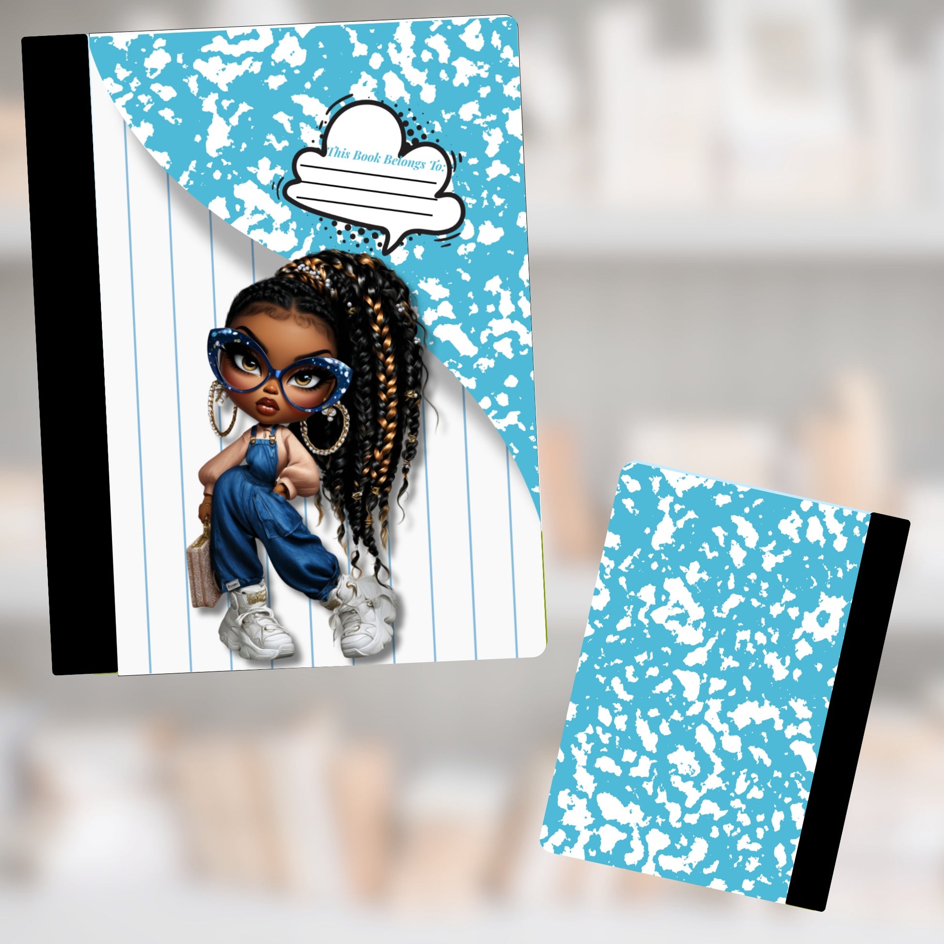 Composition notebook with a young girl illustration and blue speckled cover.