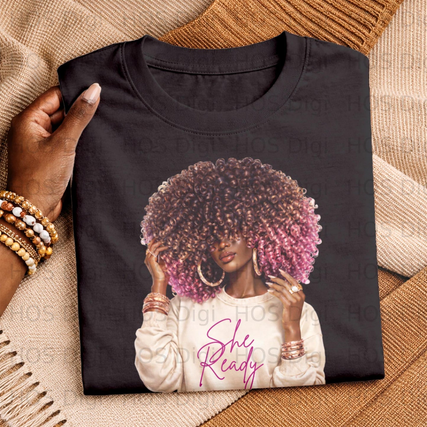 Woman with large, pink-tipped afro wearing a light sweater with "She Ready" text.