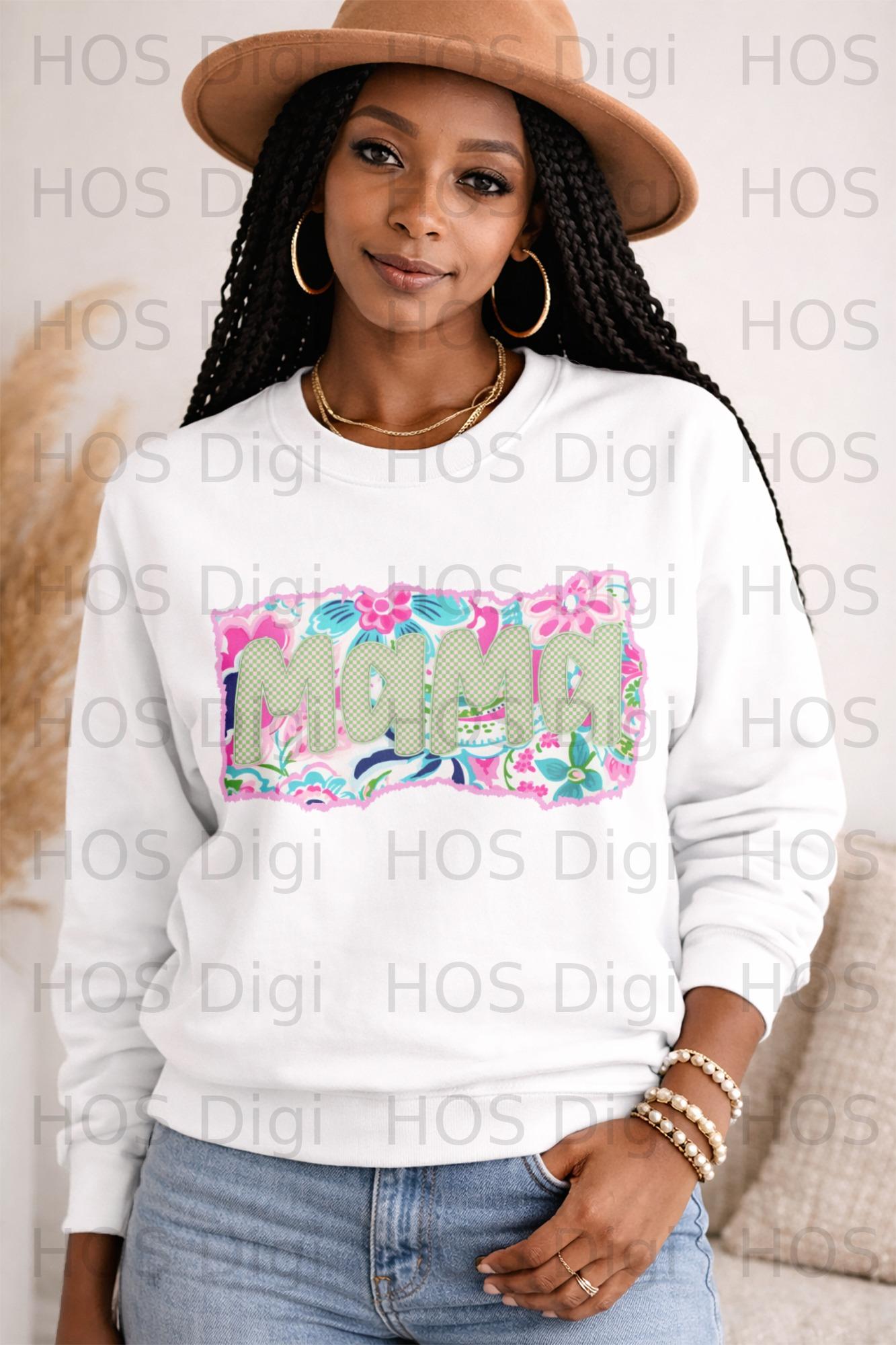Woman wearing a white sweatshirt with "MAMA" in floral and checkered pattern.