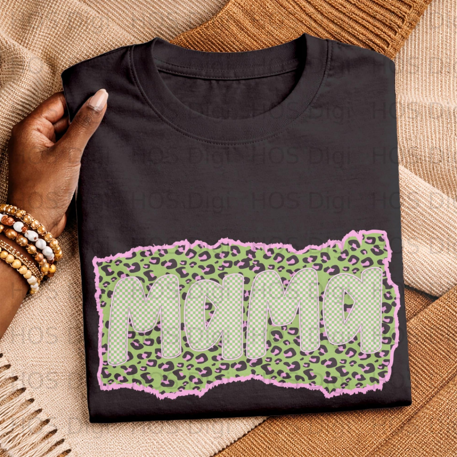 Black t-shirt with distressed "MAMA" text in checkered pattern on pink leopard print.