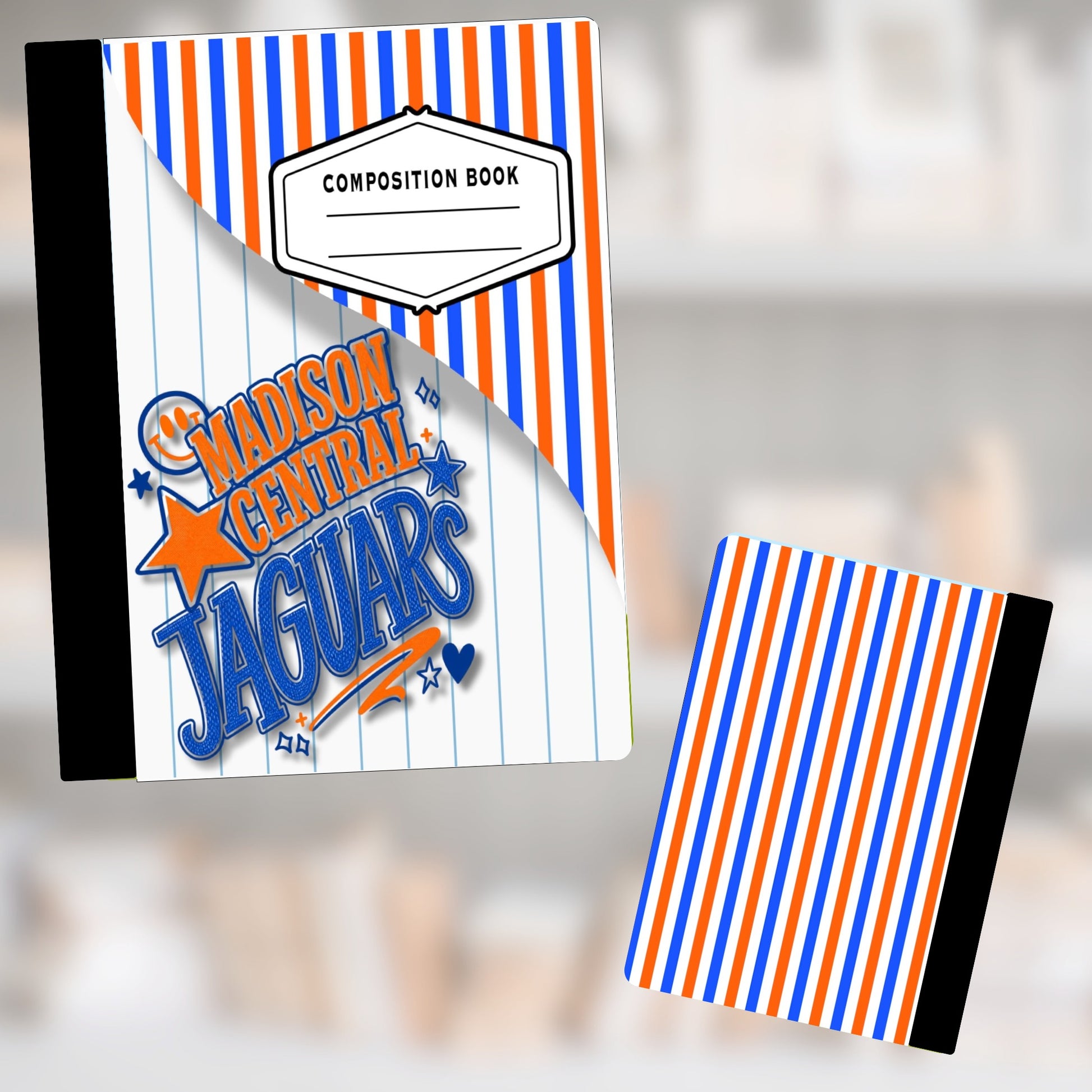 Composition book with "Madison Central Jaguars" logo and orange and blue stripes.