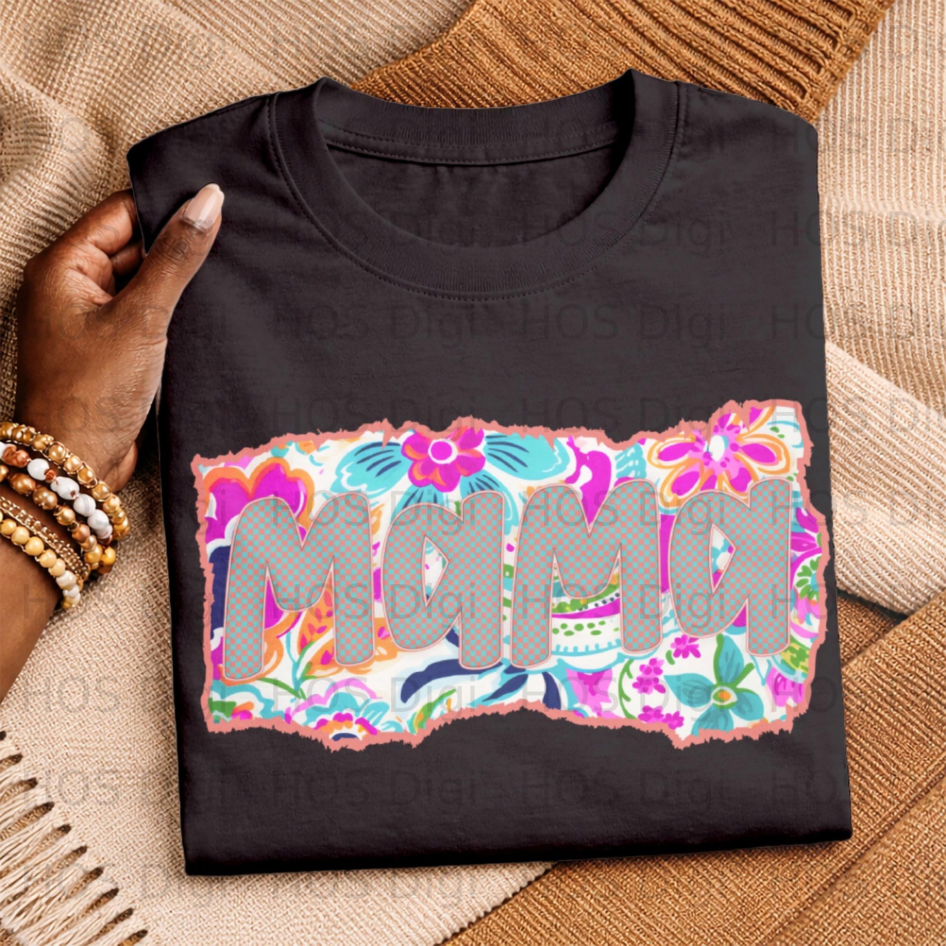 Black t-shirt with "Mama" in floral pattern lettering.
