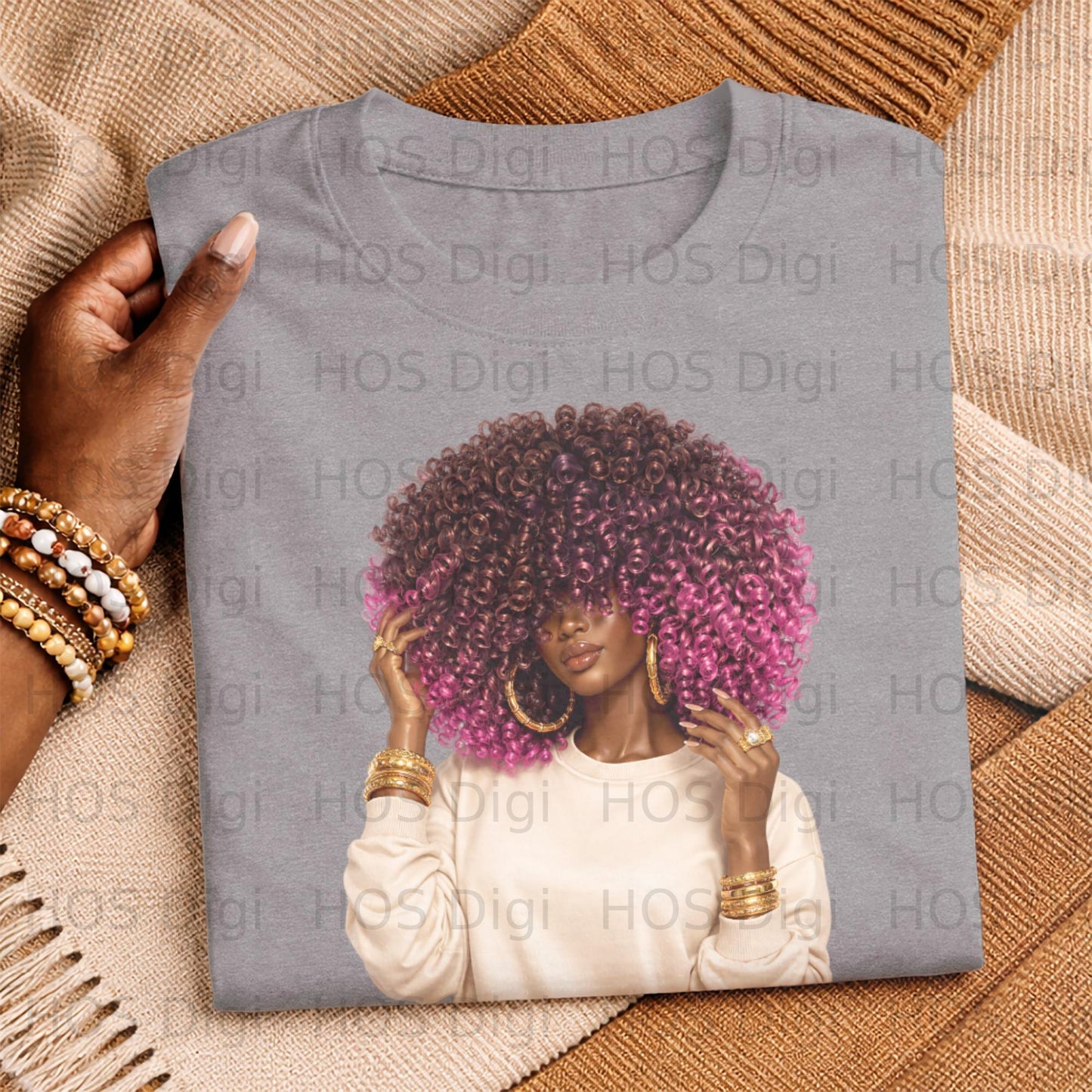 Woman with vibrant pink curly hair wearing a cream sweatshirt and gold jewelry.
