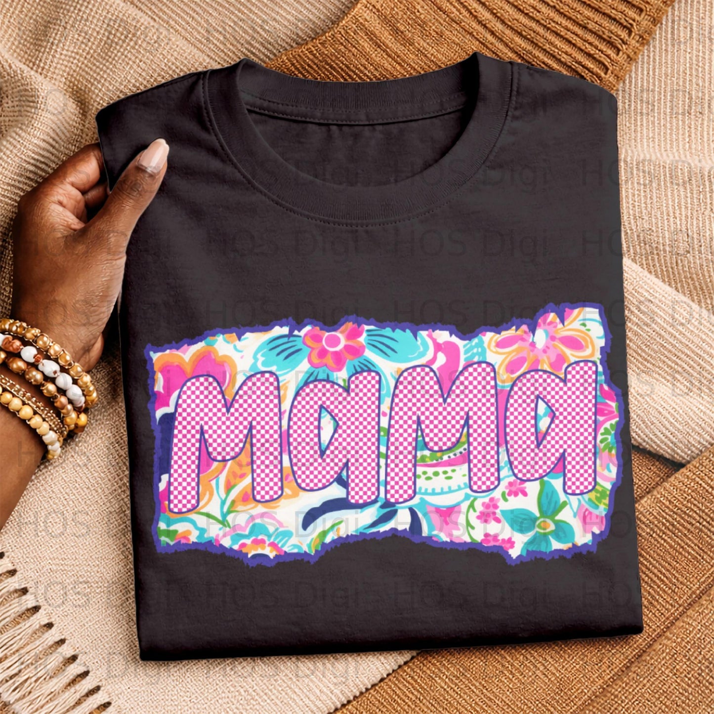 Black t-shirt with "Mama" in colorful floral and plaid pattern.