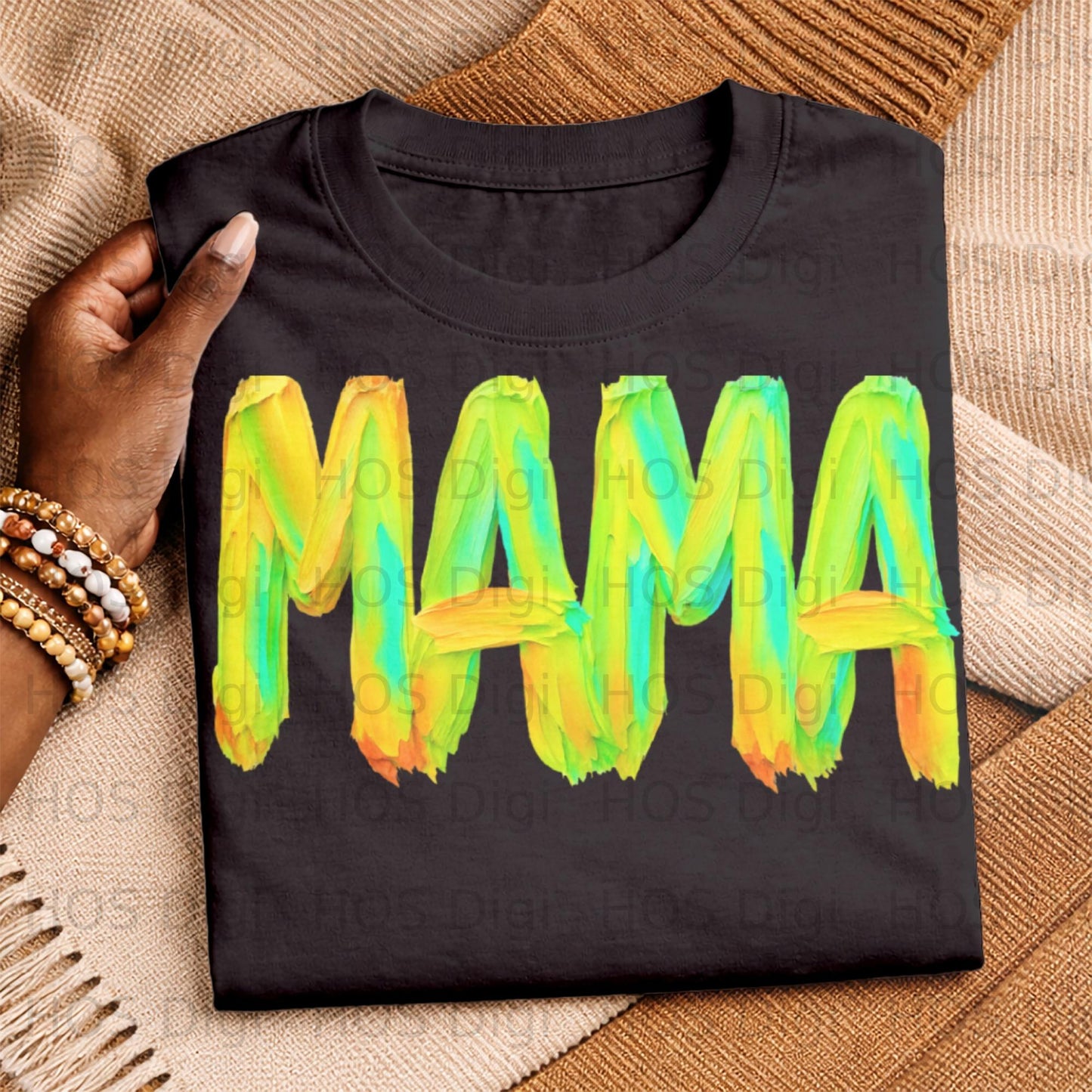 Black t-shirt with "MAMA" in bold, colorful, brushstroke text.