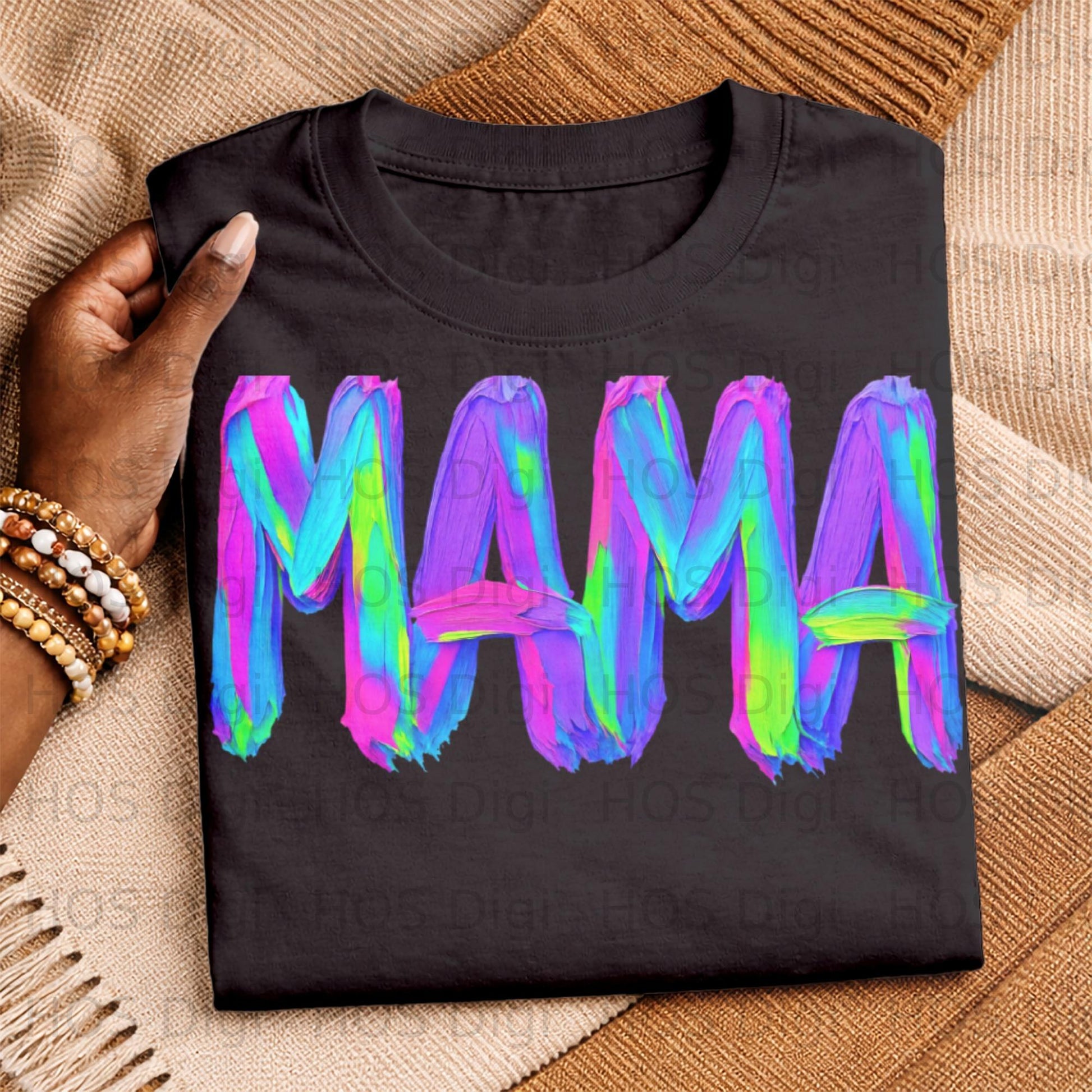 Black t-shirt with colorful "MAMA" text in a paintbrush stroke style.