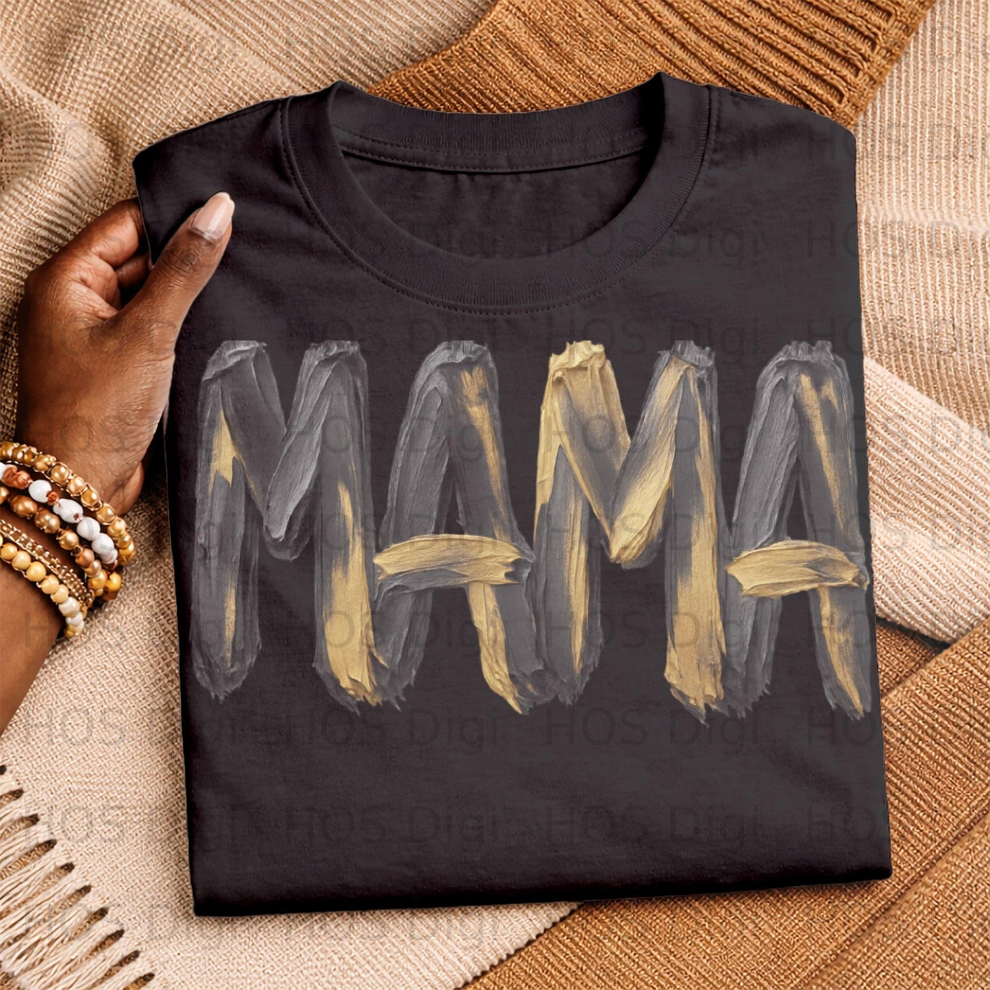 Black t-shirt with "MAMA" in textured gold and gray brush strokes.