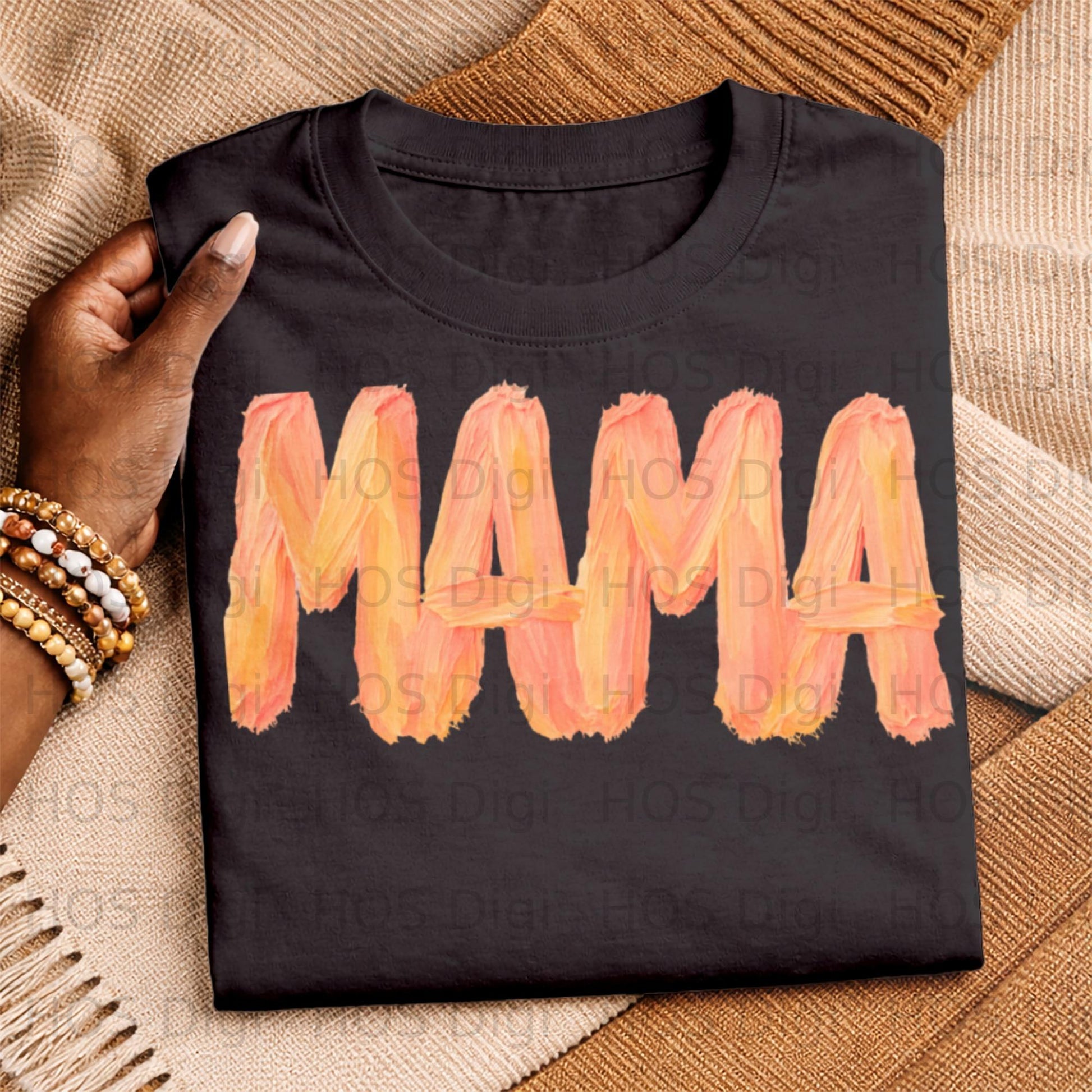 Black t-shirt with "MAMA" in orange and yellow watercolor lettering.