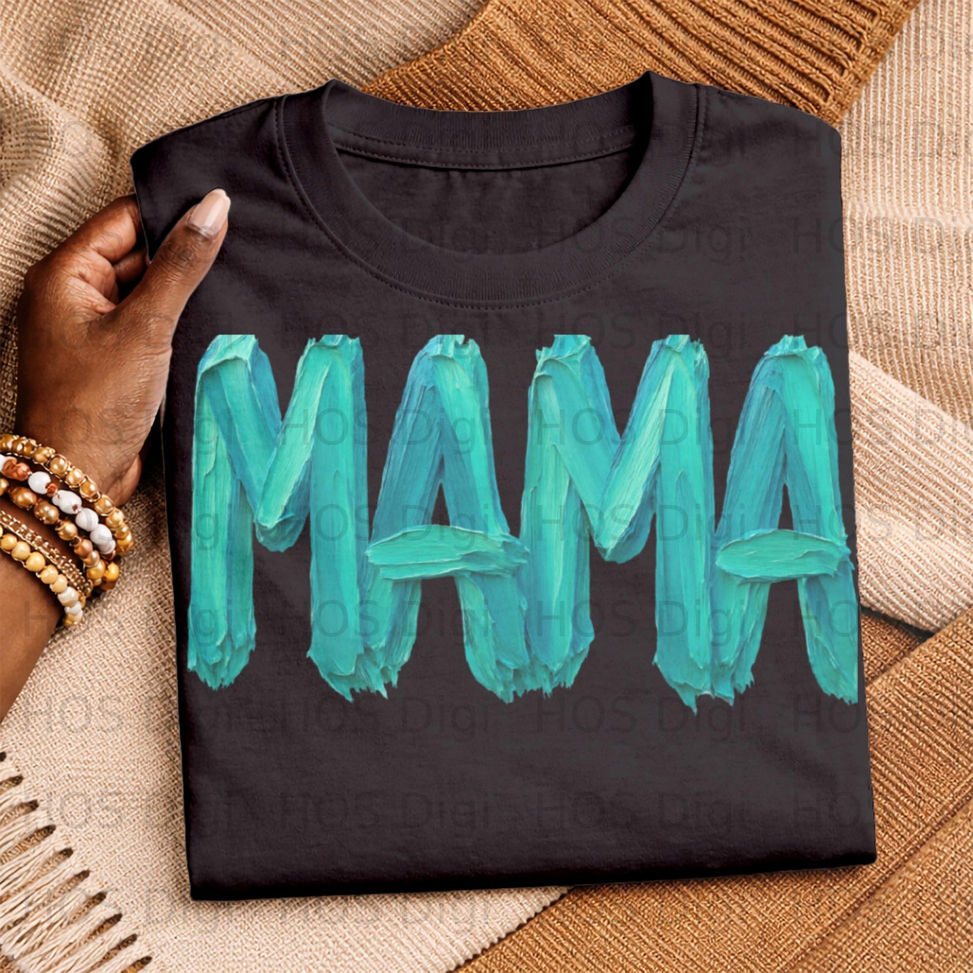 Black t-shirt with "MAMA" in teal brushstroke font.