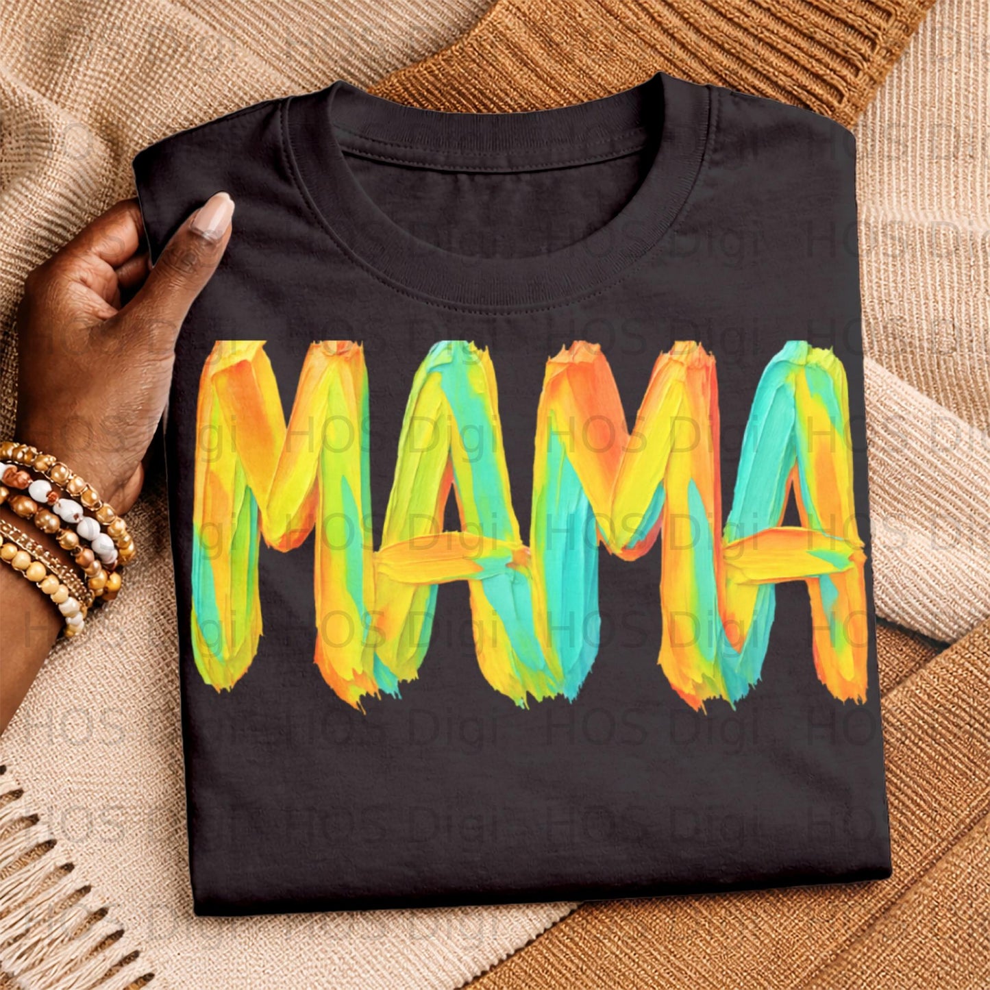 Black t-shirt with colorful "MAMA" text in brushstroke font.