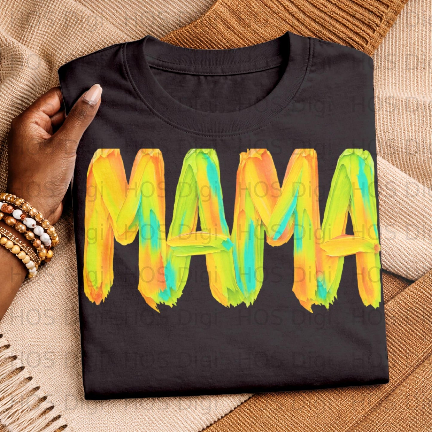 Black t-shirt with "MAMA" in colorful brushstroke letters.