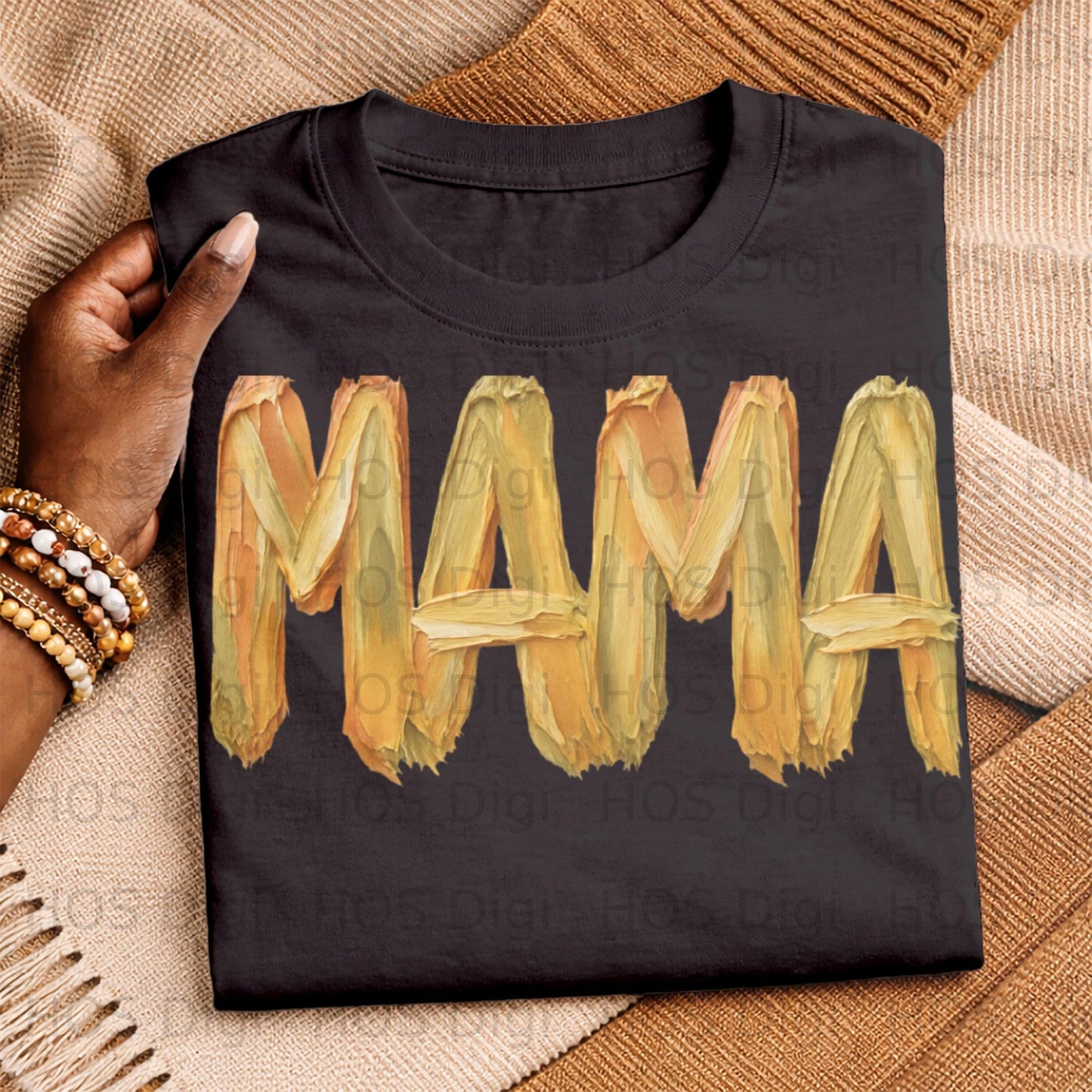 Black t-shirt with "Mama" in textured yellow and orange paint strokes.