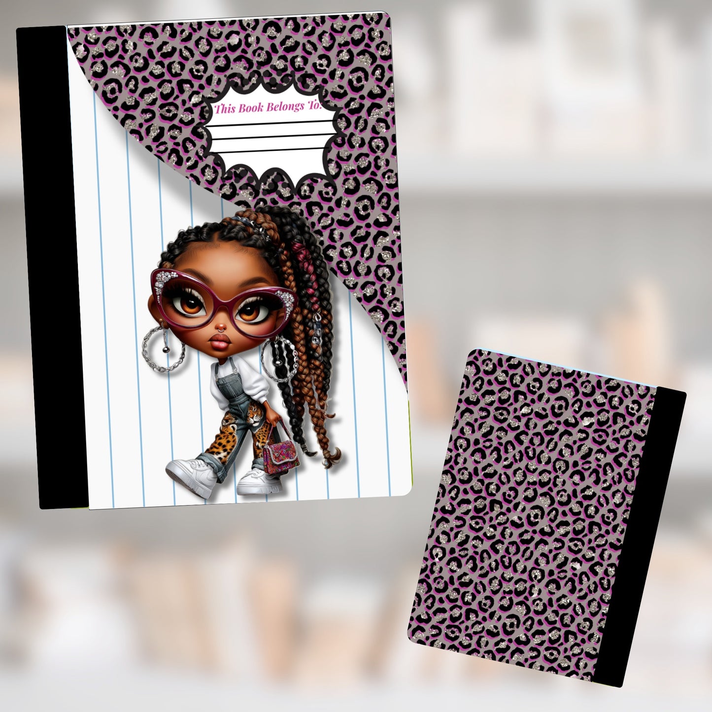 Notebook with a stylized girl, leopard print, and "This Book Belongs To" inscription.