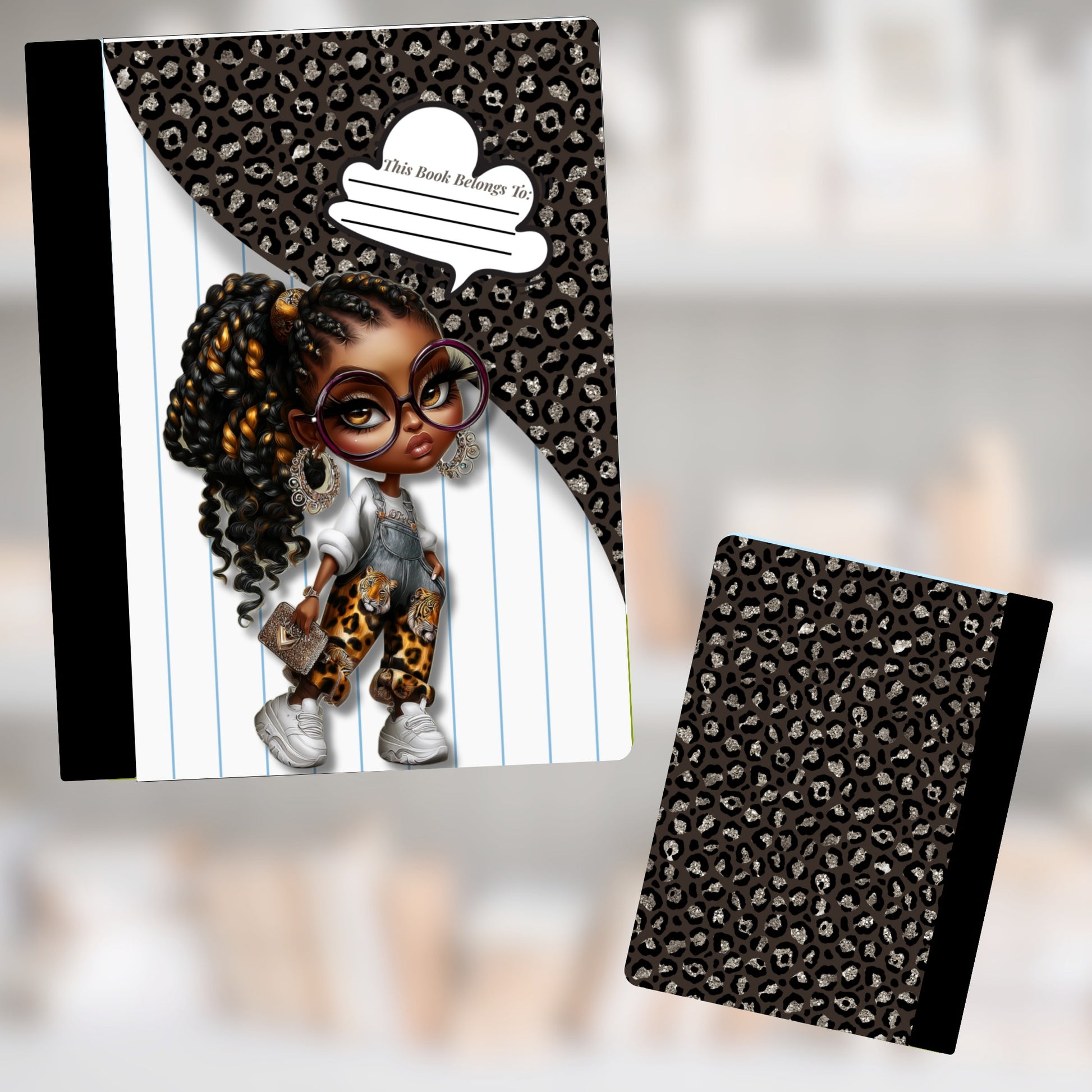 Notebook with cartoon girl and leopard print on cover, "This Book Belongs To:" text.