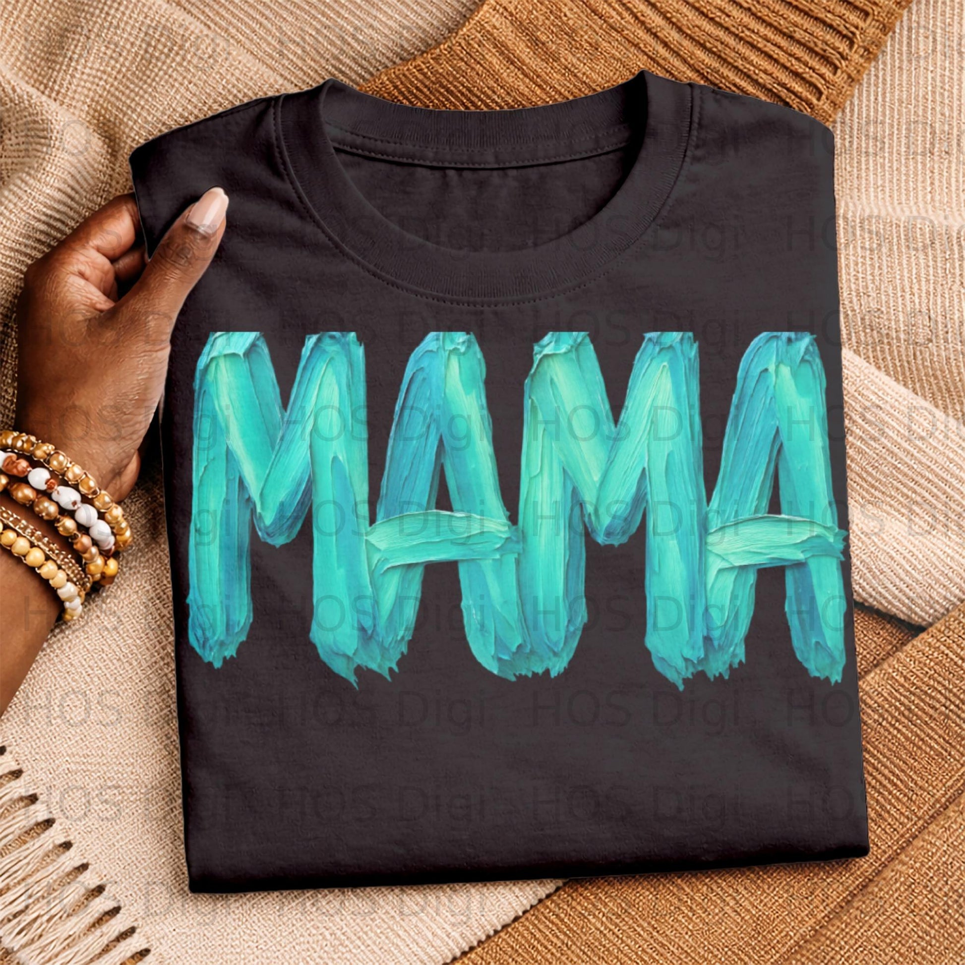 Black t-shirt with "MAMA" in turquoise paint brush stroke letters.